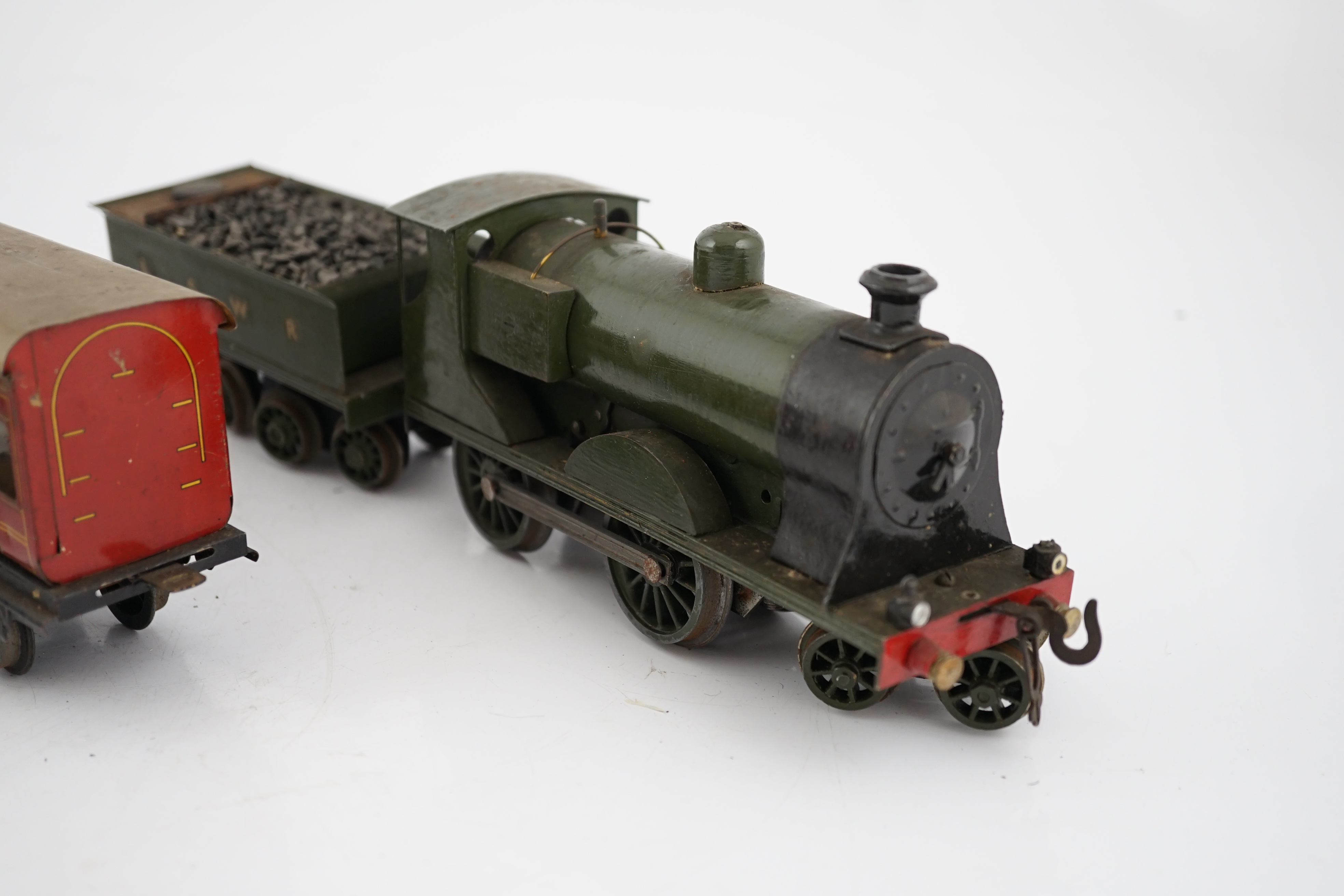 Ten 0 gauge tinplate railway items, most adapted from other parts and models, including three clockwork locomotives; n LSWR 4-4-0 tender loco, an LMS 0-4-4T loco and an SR 0-4-2T loco, together with four SR 4-wheel coach